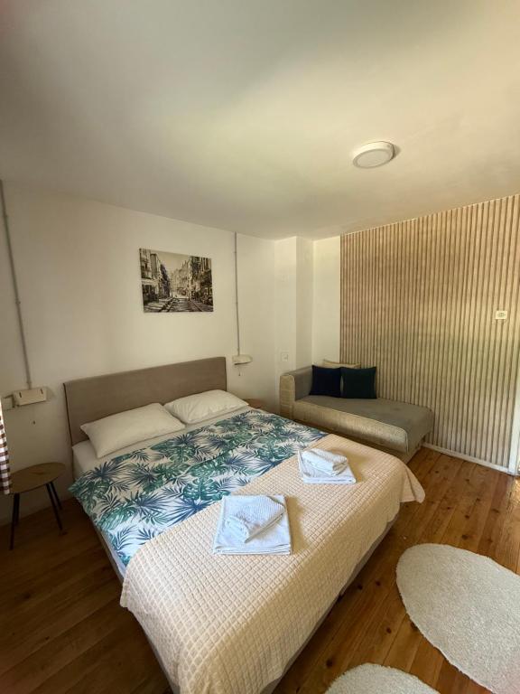 a bedroom with a bed with two towels on it at WIN apartment in Plužine
