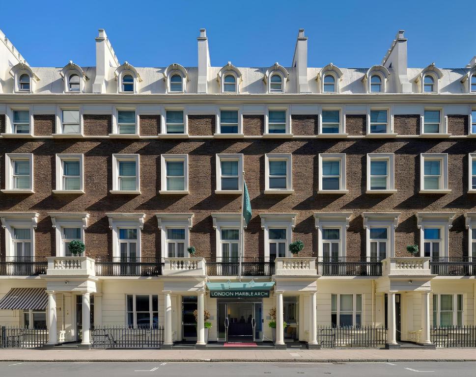 a large red brick building with white windows at Guild Hotel Marble Arch in London