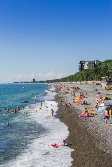 a group of people on a beach in the water at LouNik Kobuleti in Kobuleti