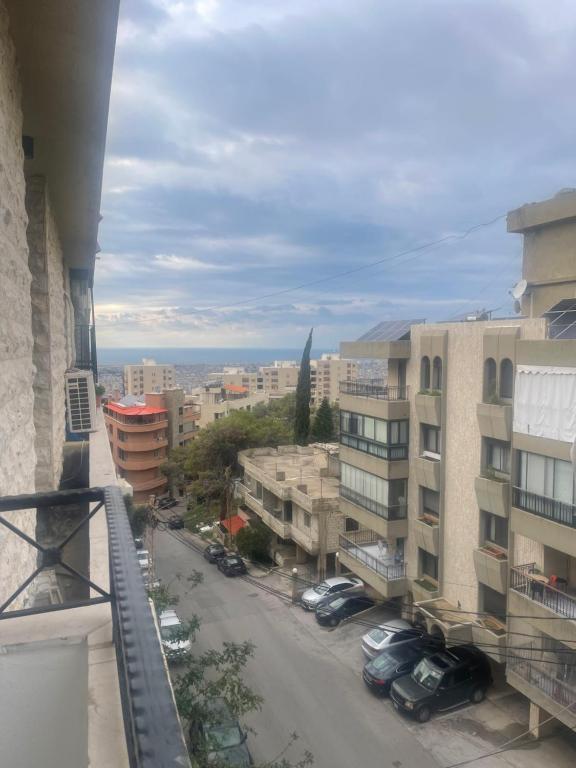 a view of a city street from a balcony at Haidar house in Baabda