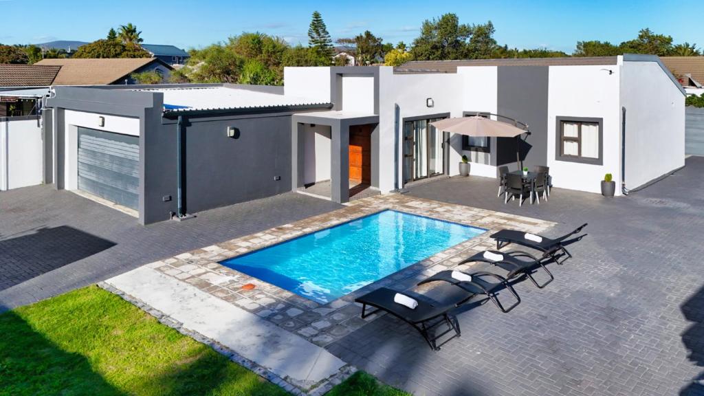 an image of a house with a swimming pool at Cozier Glitz in Cape Town