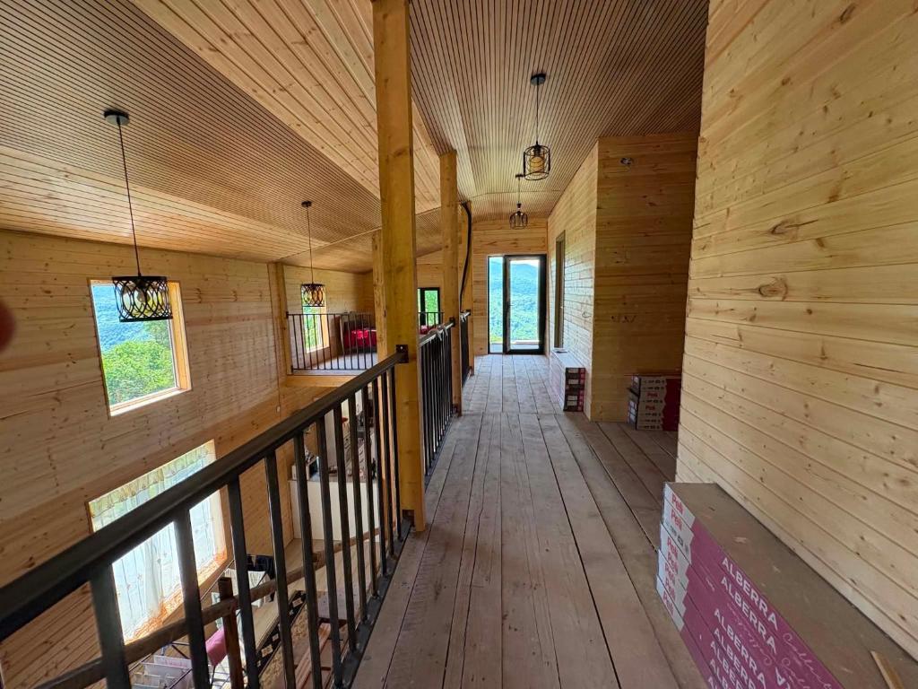 an empty hallway of a wooden cabin with wooden walls at Natas Saxli in K'vemo Zhoshkha