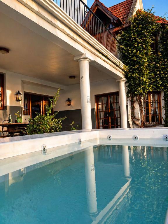 a large swimming pool in front of a house at Why Not Guemes in Córdoba