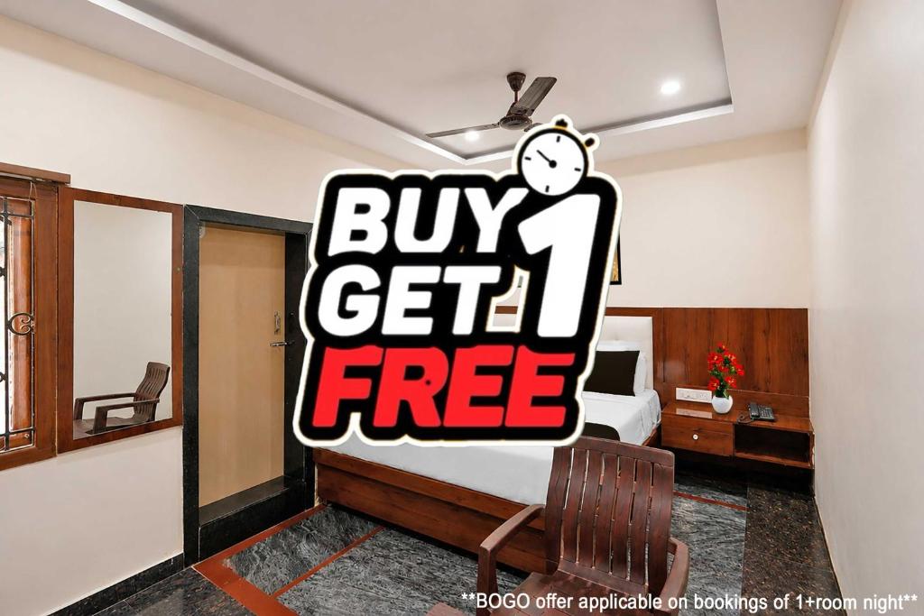 a bedroom with a bed with a buy get free sign at Collection O Tennati Park Vizag Beach Formerly B Square Villa in Visakhapatnam