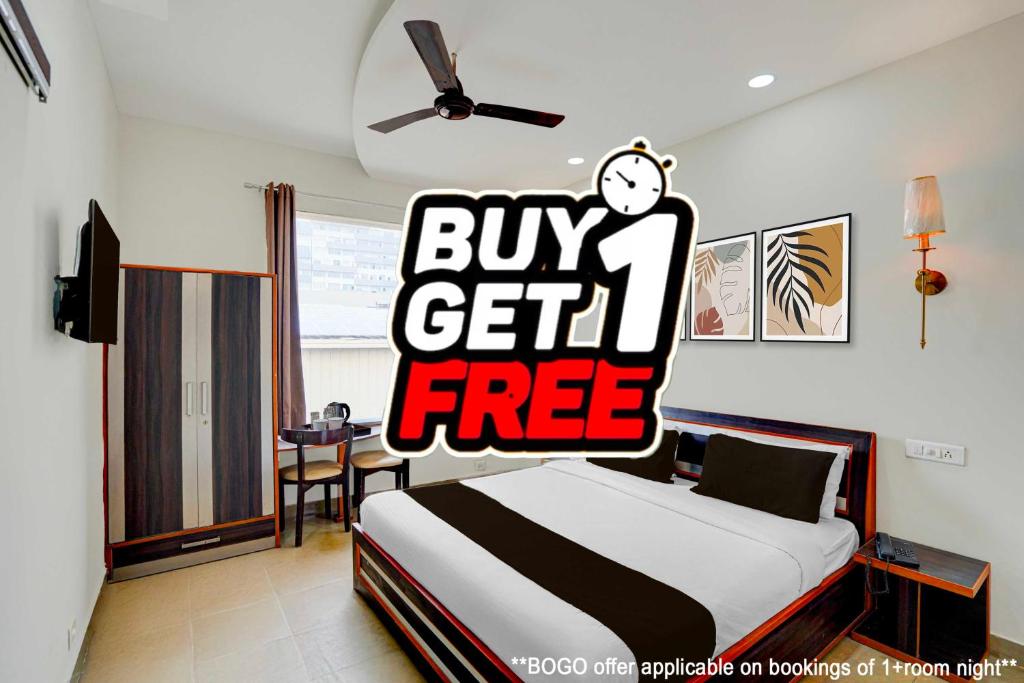 a bedroom with a bed with a buy get free sign at Super Townhouse by OYO Cosmo Mall Zirakpur Formerly R K Residency in Zirakpur