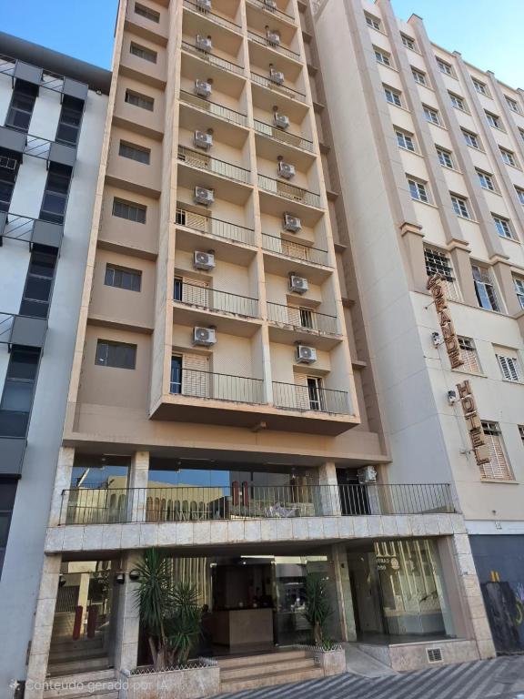 a tall building with balconies on it at Grande Hotel Havana - Hospedagem Econômica in Uberaba