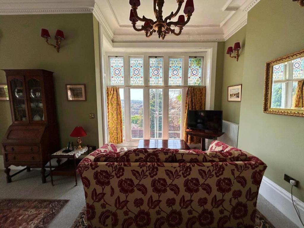 a bedroom with a bed and a large window at The Vicar's View at the Old Vicarage in Lincoln