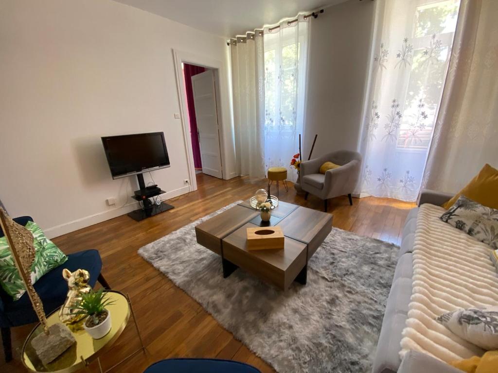 a living room with a couch and a coffee table at Le Grand 27 in Guebwiller
