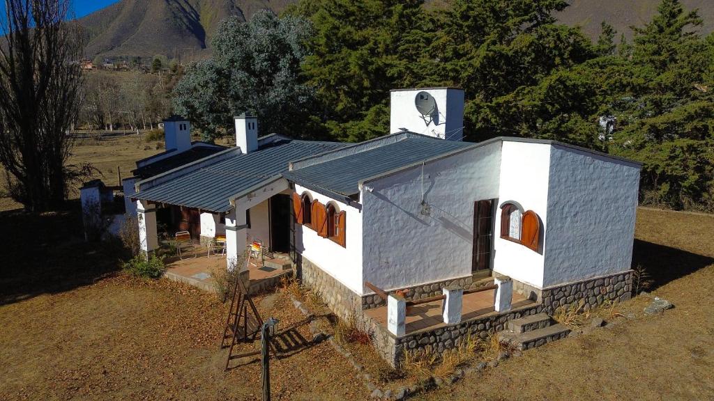 a small white house with a metal roof at Casa Luna Bca in El Mollar