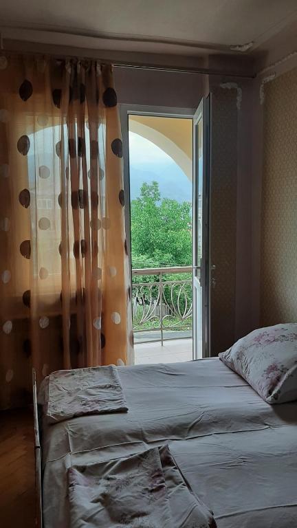 a bedroom with a bed and a large window at Saraharth in Alaverdi