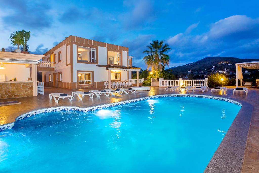 a villa with a swimming pool at night at Villa Solaris in Sant Jordi