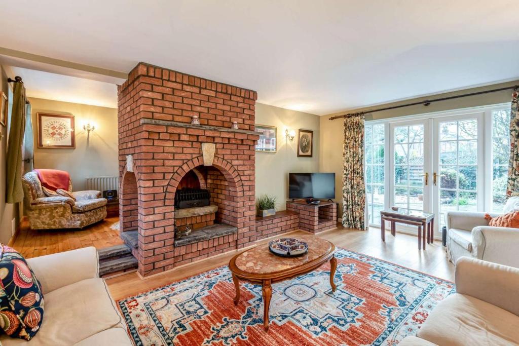 a living room with a brick fireplace at 3 Bed in Lincoln oc-90396 in Washingborough