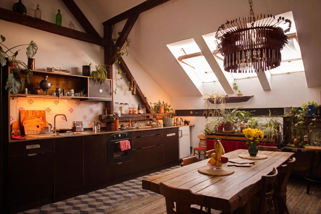 a kitchen with a wooden table in a room at Das Nest Budapest in Budapest