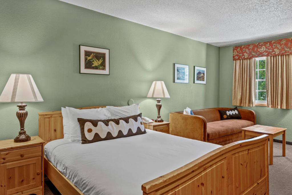 a bedroom with a bed and a couch and a chair at Old Town Inn in Crested Butte