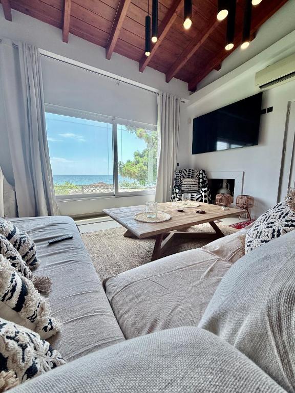 a living room with a couch and a table at Casa Blue in Panayía Mesosporítissa