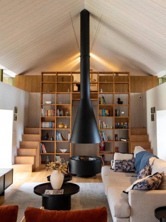 a living room with a couch and a fireplace at Casa da Fonte de Cima in Celorico de Basto