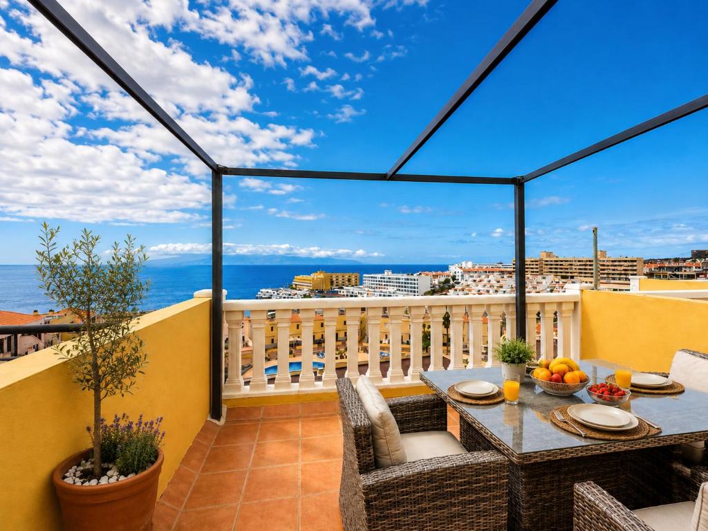a balcony with a table and a view of the ocean at Ocean Front Teneriffa 2 Bedroom Penthouse Costa Adeje in Callao Salvaje