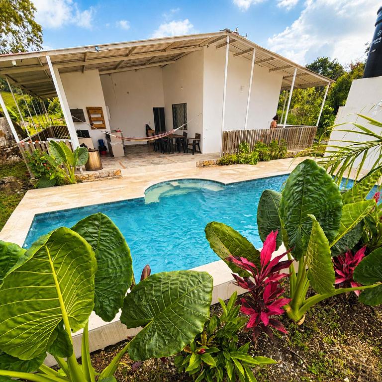 a swimming pool in front of a house at Casa Jaguar Viotá in Viotá