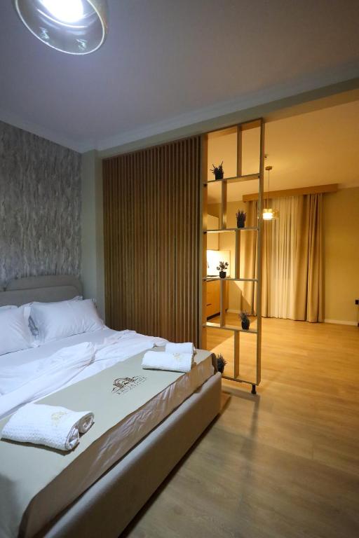 a bedroom with a large bed with towels on it at Kruja Gate in Krujë