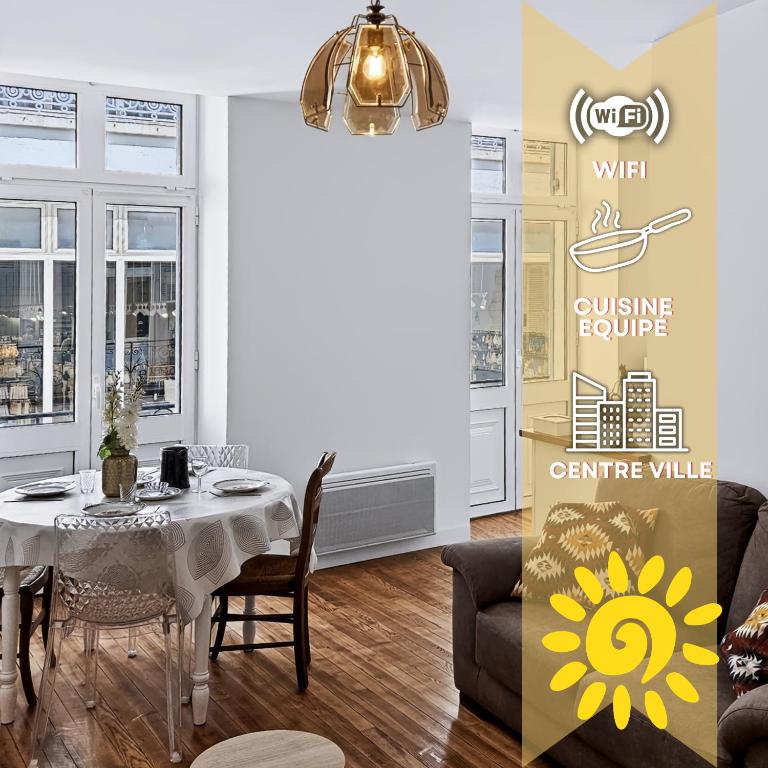 a dining room with a table and a yellow sign at Le Citadin - Centre - Wifi - Balcon in Dax