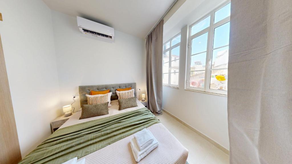 a white bedroom with a bed and a window at Lobster Room - Estrela do Mar - 1 in Albufeira