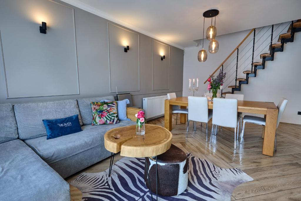 a living room with a couch and a table at Luxury Heaven Apartment - 116 m2 Fireplace 3 bedroom - Free Parking in Katowice