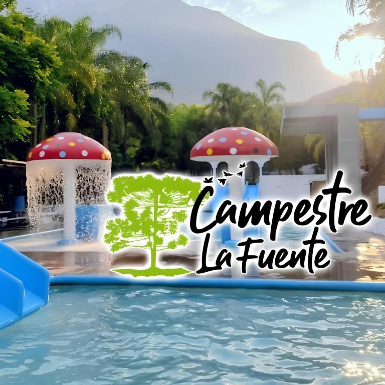a resort with a water park with a fountain and trees at Campestre La Fuente in Monterrey
