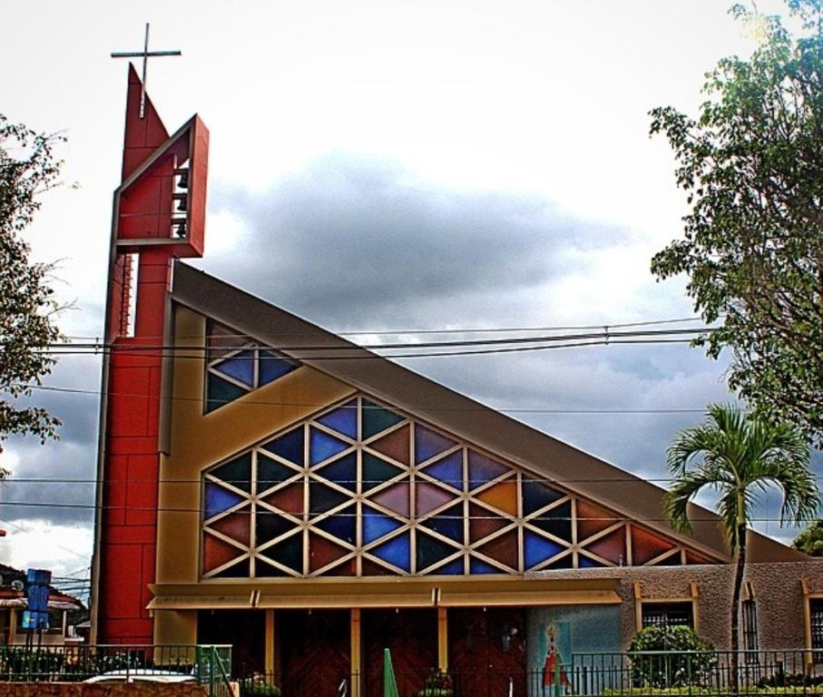 a church with a cross on top of it at Studio comodo con aire acondicionado in Caguas