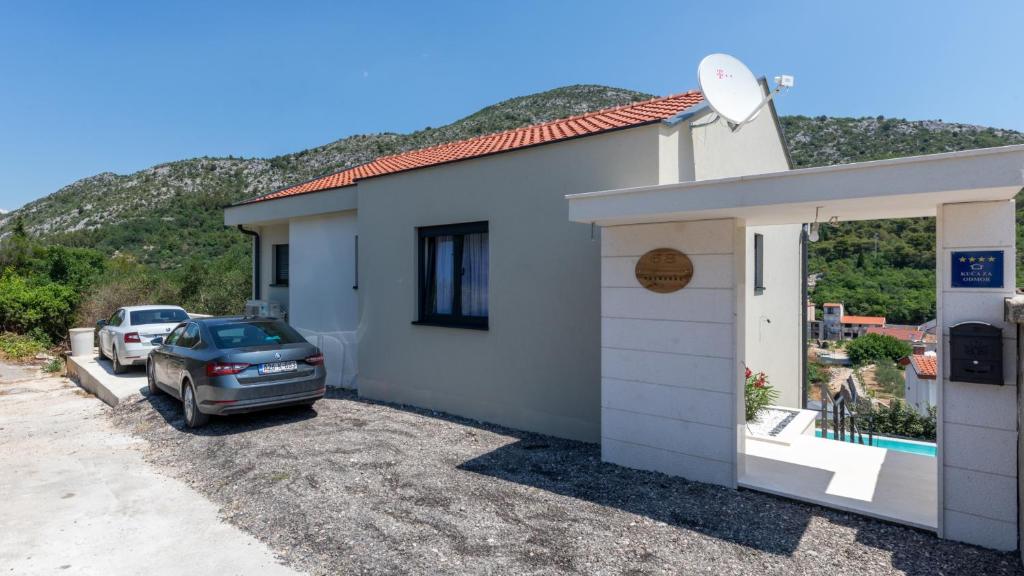 a small white building with a car parked next to it at Villa Tea - Kremena by Villas Guide in Blace