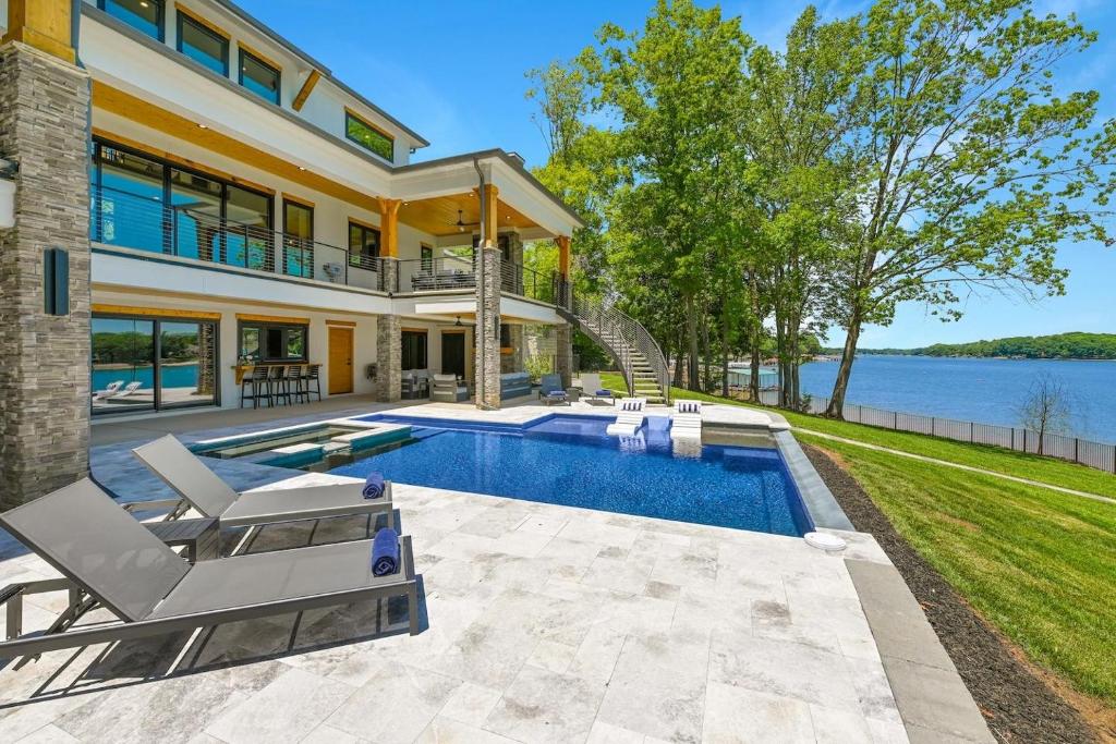 a home with a swimming pool and a house at Willow Landing in Troutman