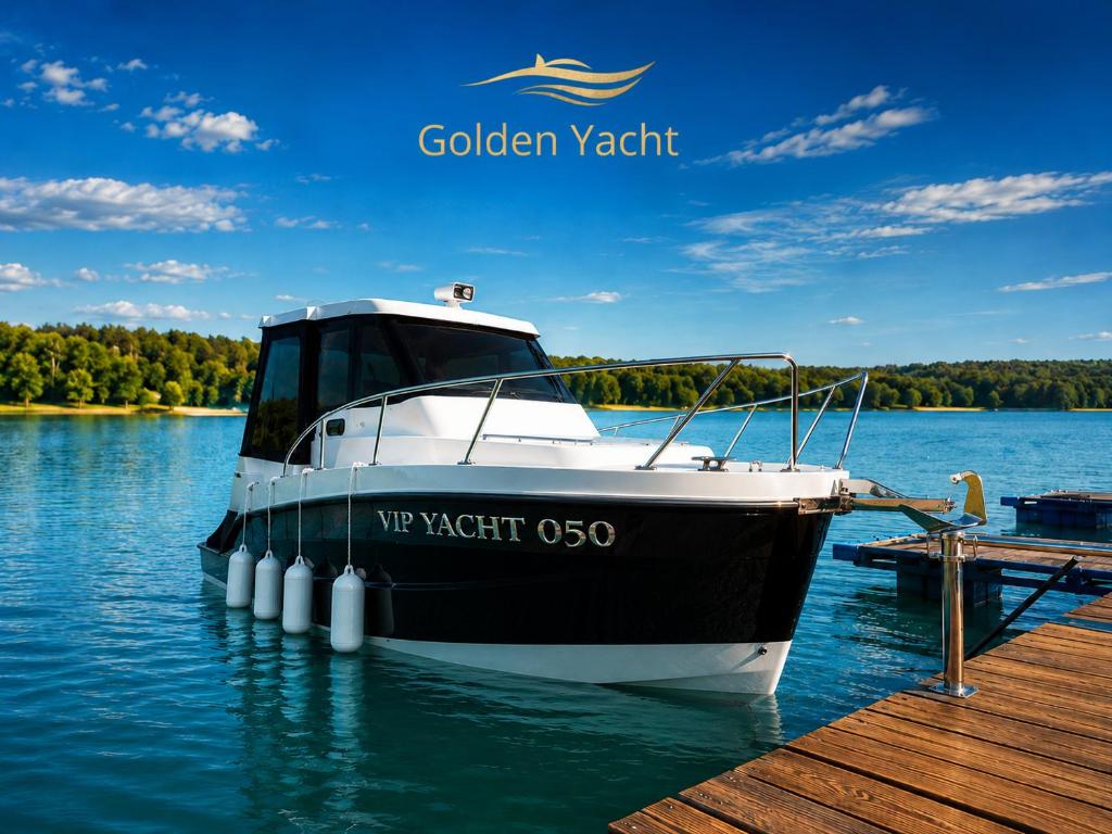 a black and white boat parked at a dock at Golden Yacht Solina in Polańczyk