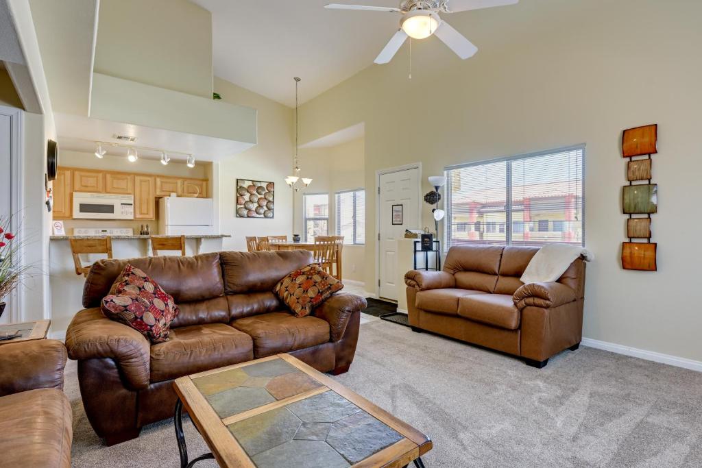 a living room with leather furniture and a kitchen at Golf & Gamble! Mesquite Condo w/ Pool Access in Mesquite