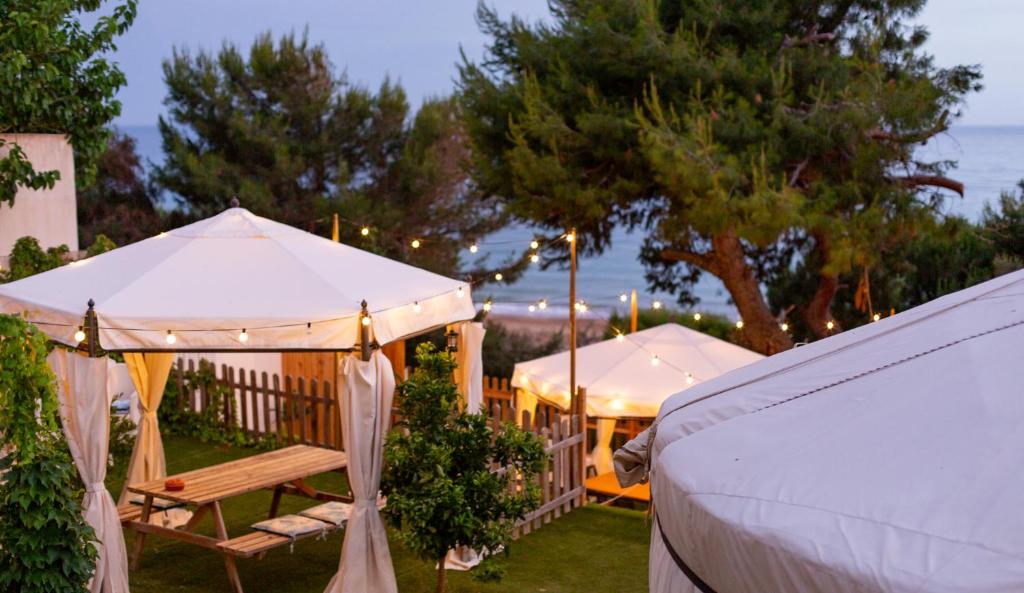 a gazebo and a bench in a yard at Yurta Glamping B&B San Leone Agrigento - tra mare e pineta in Agrigento