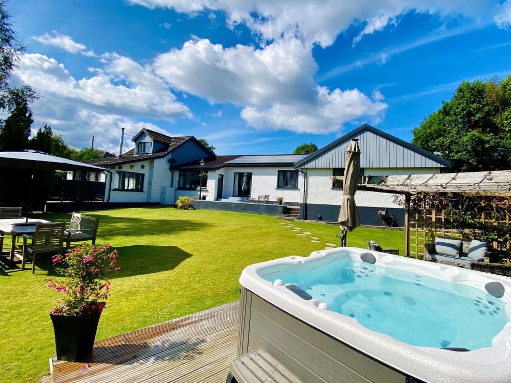 a hot tub in the yard of a house at Distant Hills Guest House in Spean Bridge