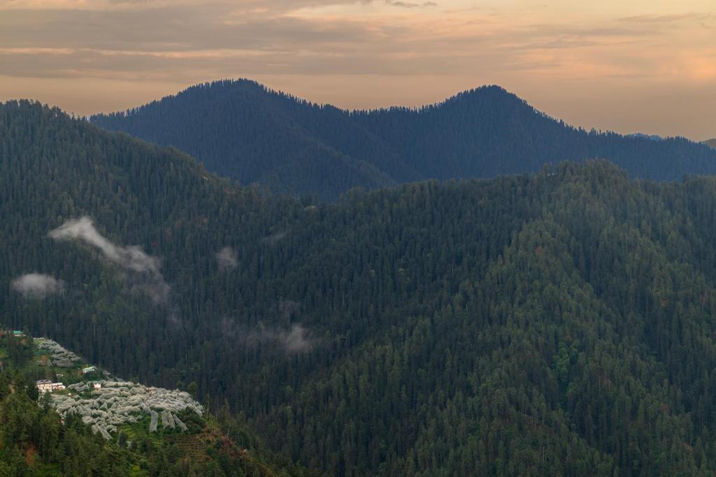 a view of a mountain with trees and houses at Narkanda Heights by Splendid Retreat Hotels in Nārkanda