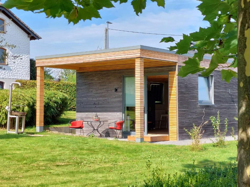 a pavilion with a table and chairs in a yard at Gartenlodge im Grünen in Feuerscheid