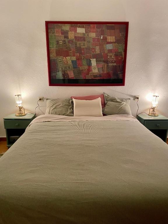 a bedroom with a large bed with two lamps at Casa Coco No 11 in Polopos