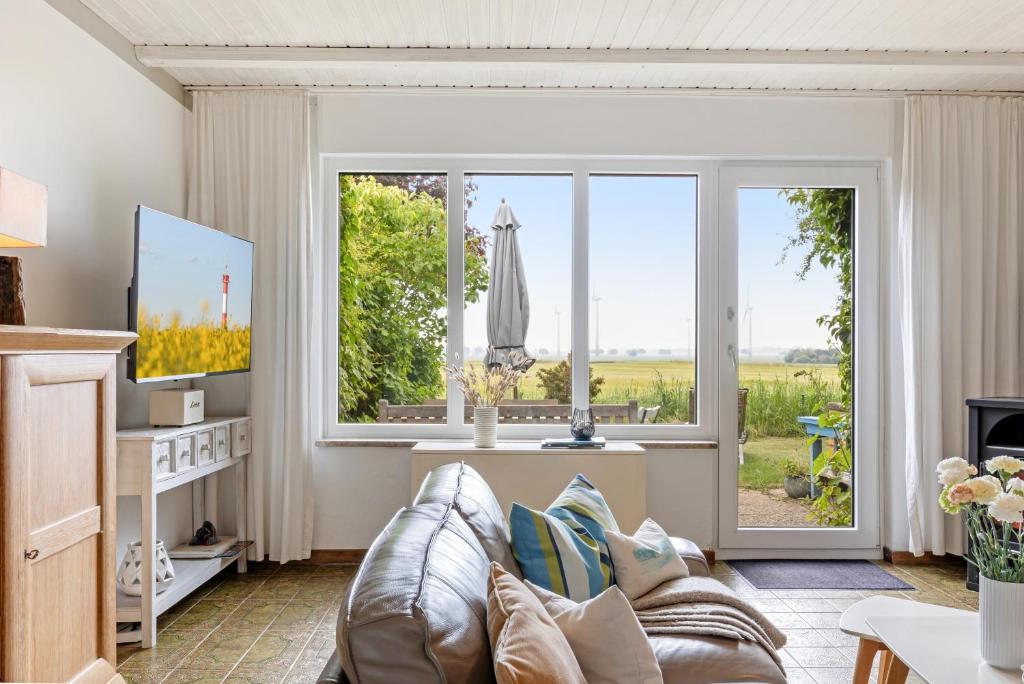 a living room with a couch and a window at Ferienhaus Marienleuchte in Marienleuchte