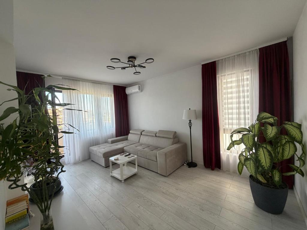 a living room with a couch and a table at Royal Five Urban in Bucharest