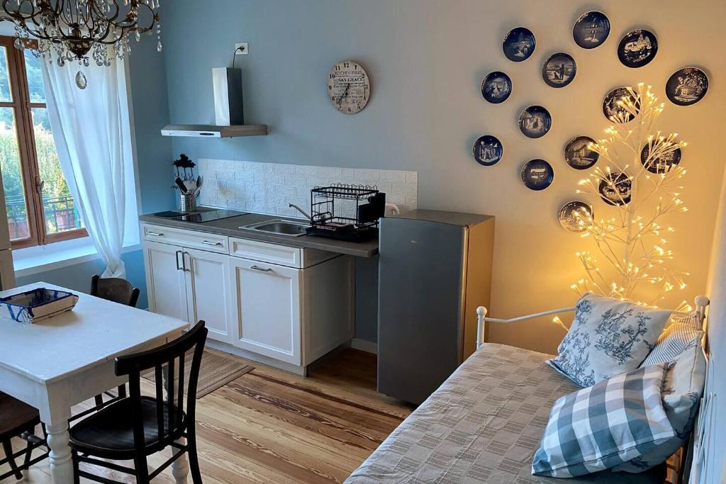a kitchen with a table and a kitchen with a refrigerator at Cascina Vica Biella in Andorno Micca
