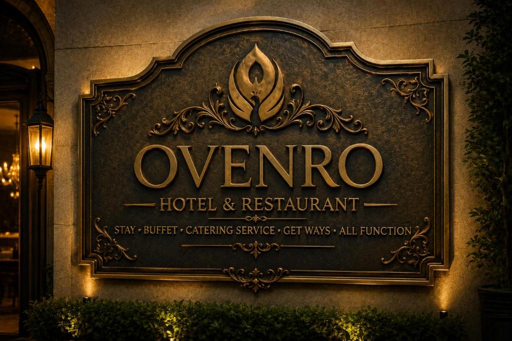 a sign for a hotel and restaurant on a wall at Ovenro Safari Hotel & Restaurant Yala, Kataragama in Kataragama