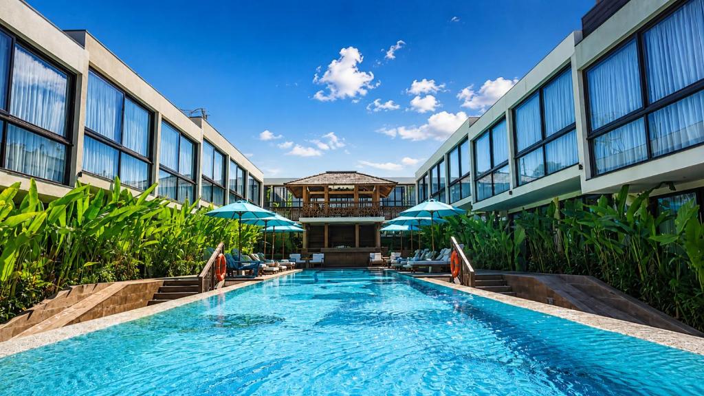 a swimming pool in front of a building at Awwa Boutique Hotel in Canggu