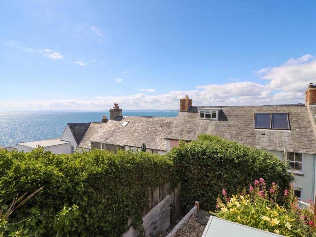 an image of a house with the ocean in the background at Arosfa in New Quay