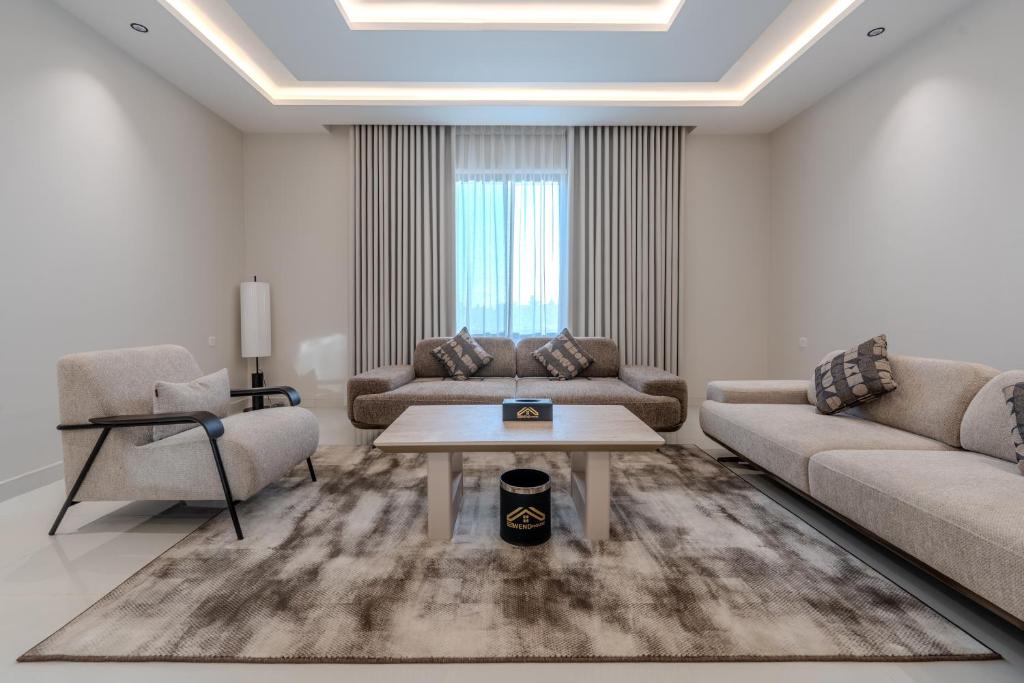 a living room with two couches and a coffee table at wend house in Jeddah
