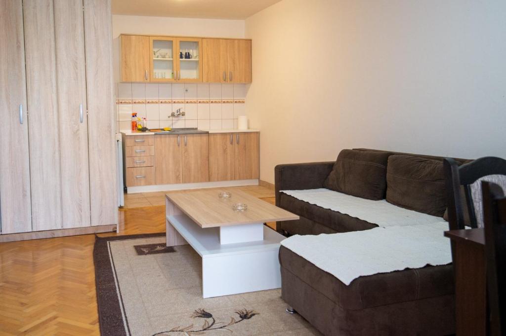 a living room with a couch and a table at Apartman in Trebinje