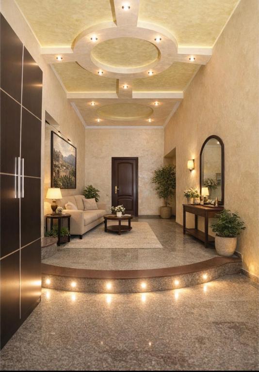 a lobby with a couch and a room with lights at Eriks Guest House in Goris