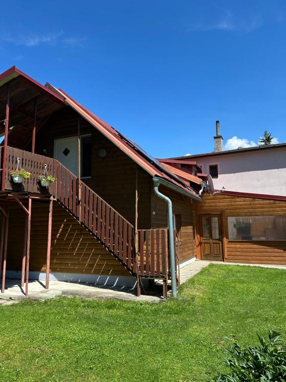 a house with a staircase on the side of it at Apartmán Gál 2 in Kvačany