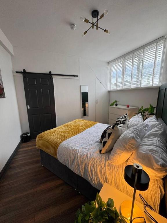 a bedroom with a large bed and a ceiling fan at The Recharge Loft in Durham
