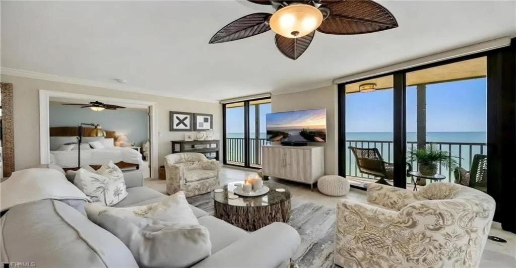a living room with a white couch and a bed at Oceanview Serenity Escape in Naples