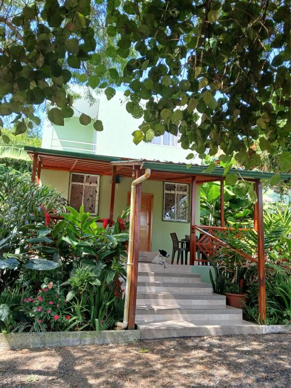 a house with a staircase leading to the front porch at Finca Paraiso retiros holisticos in San Clemente